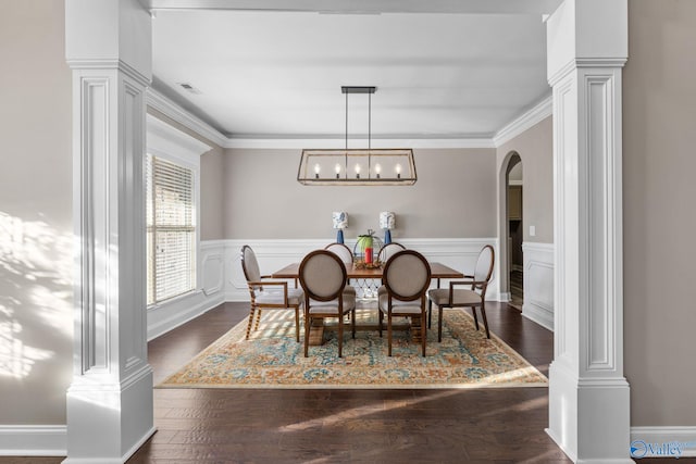 dining area with visible vents, ornate columns, arched walkways, and wainscoting