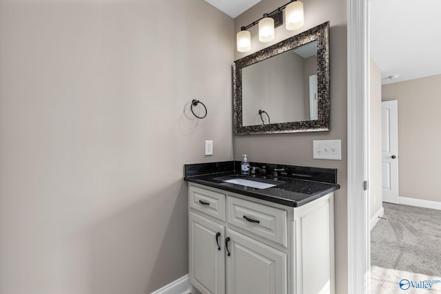 bathroom with vanity and baseboards
