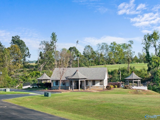 view of front of house featuring a gazebo and a front yard