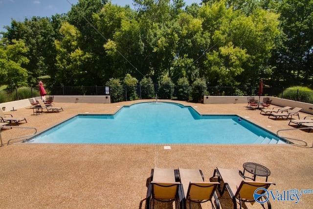 pool featuring a patio area and fence