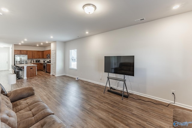 living room with dark hardwood / wood-style flooring and sink