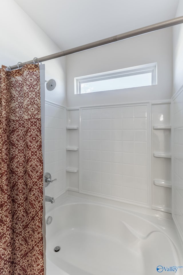 bathroom with plenty of natural light and shower / tub combo with curtain