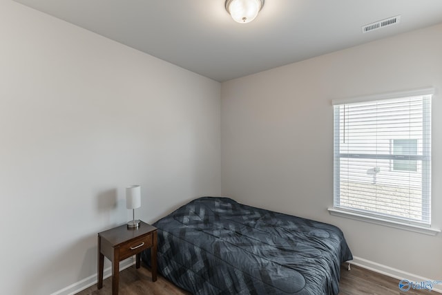 bedroom featuring dark wood-type flooring