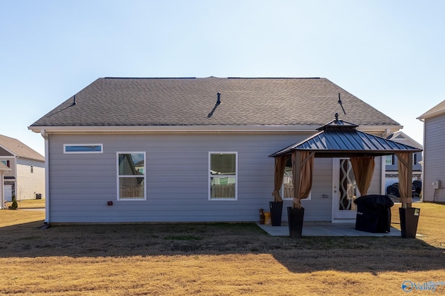 back of house with a gazebo, a patio area, and a lawn