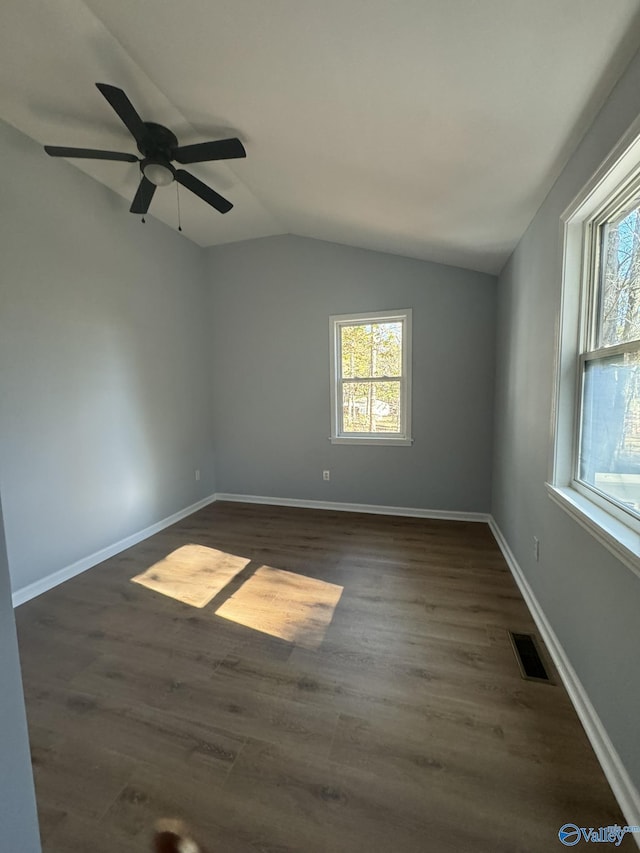 unfurnished room with dark wood-type flooring and lofted ceiling