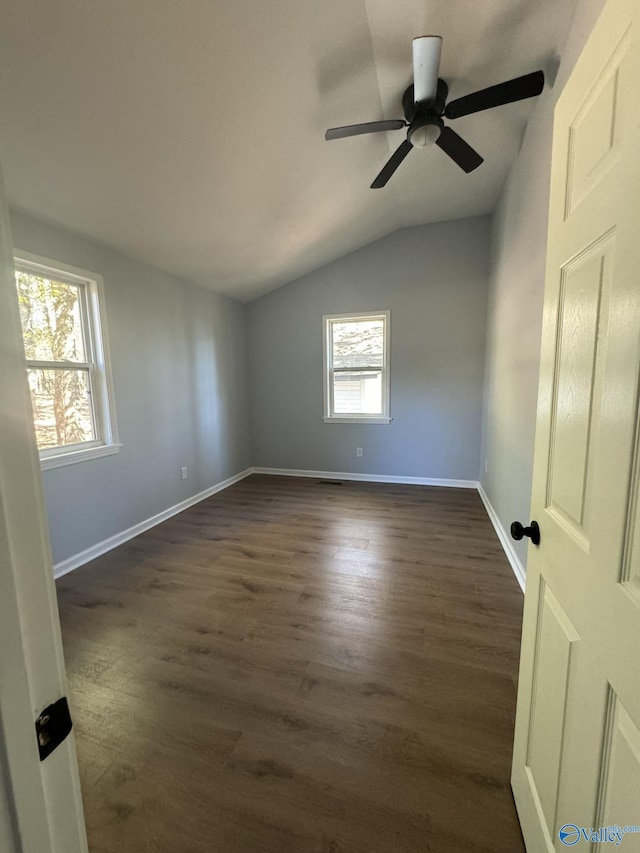 unfurnished room featuring dark hardwood / wood-style flooring, lofted ceiling, and ceiling fan