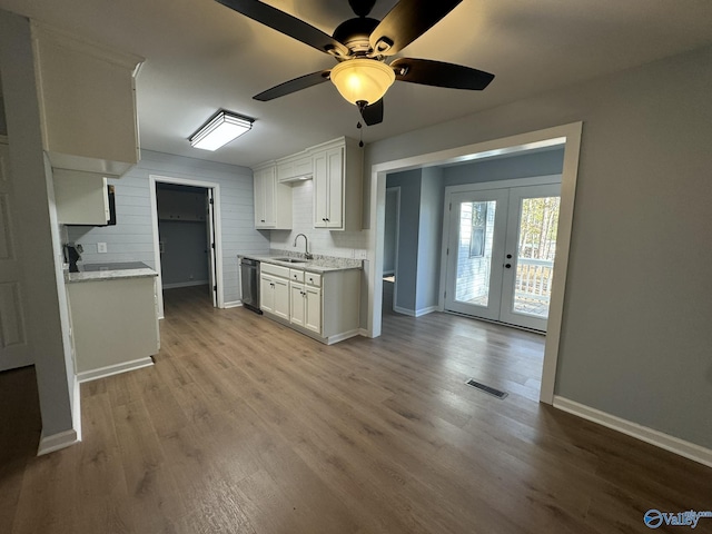 kitchen featuring sink, dishwasher, light hardwood / wood-style floors, white cabinets, and french doors