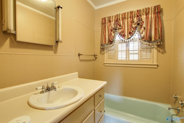 bathroom with a tub to relax in, ornamental molding, vanity, and tile walls