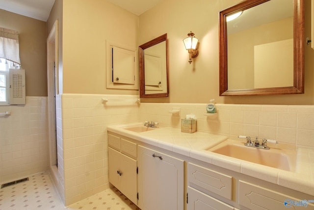 bathroom with vanity and tile walls