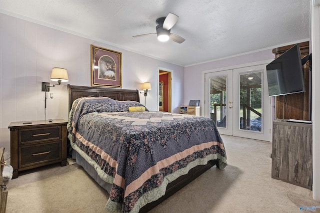 carpeted bedroom with a textured ceiling, access to exterior, ceiling fan, and french doors