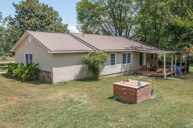 rear view of property featuring a lawn