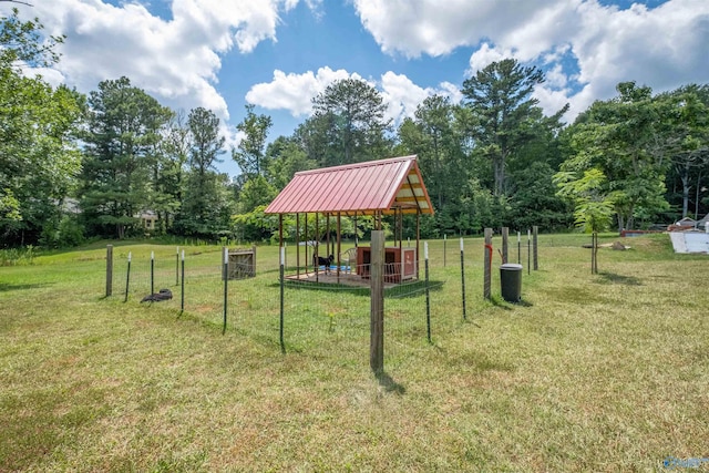 view of property's community with an outbuilding and a yard