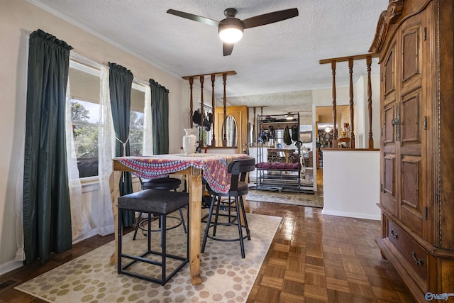 dining room with ceiling fan, a textured ceiling, and dark parquet floors