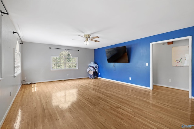 unfurnished living room with hardwood / wood-style flooring and ceiling fan