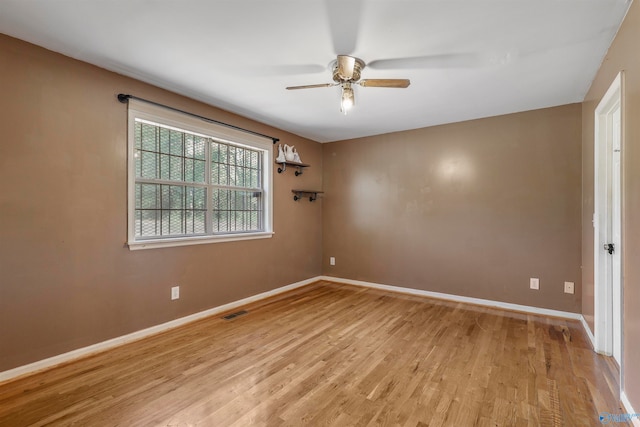 empty room with light wood-type flooring and ceiling fan