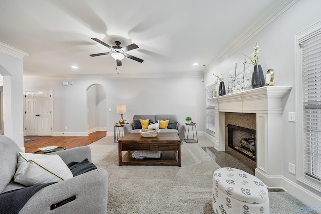 living room featuring ornamental molding and ceiling fan