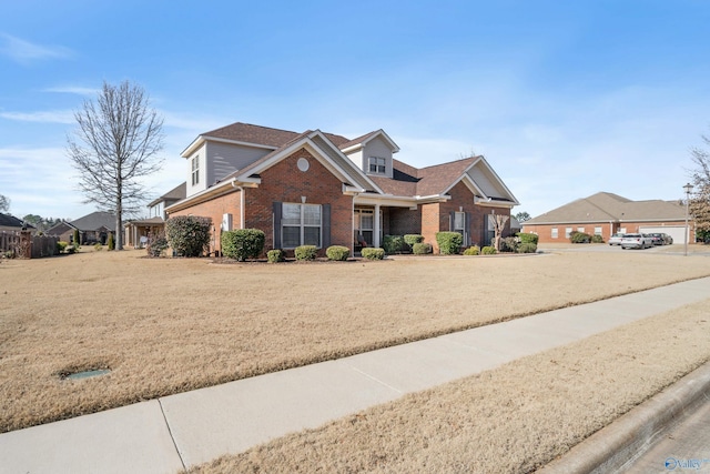 view of front of property featuring a garage and a front lawn