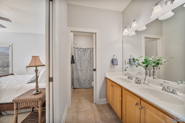 bathroom with ceiling fan, tile patterned floors, toilet, and vanity