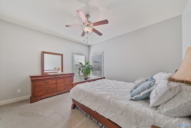 bedroom featuring light colored carpet and ceiling fan