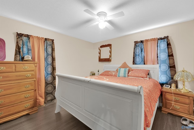 bedroom with dark wood-type flooring and ceiling fan