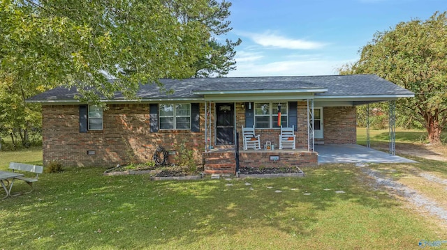 ranch-style house with covered porch, a carport, and a front yard