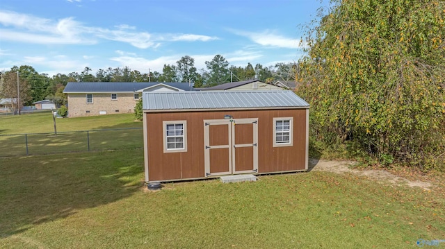 view of outbuilding with a lawn