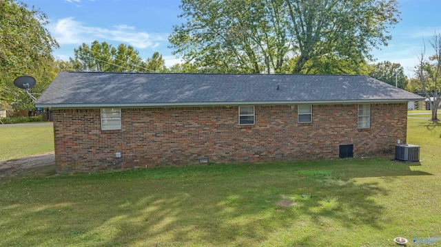 view of home's exterior with a yard and cooling unit