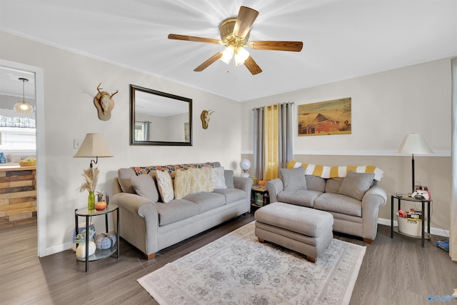 living room featuring ornamental molding, dark hardwood / wood-style floors, and ceiling fan