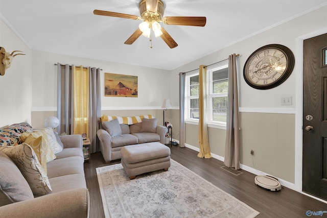 living room with crown molding, dark wood-type flooring, and ceiling fan