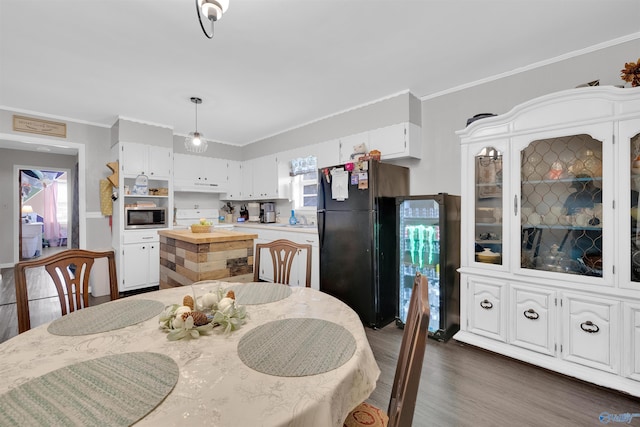 dining area with crown molding and dark hardwood / wood-style floors