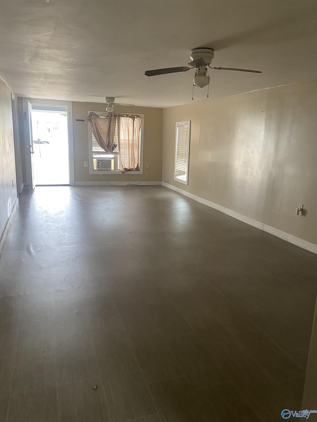 empty room featuring cooling unit and ceiling fan