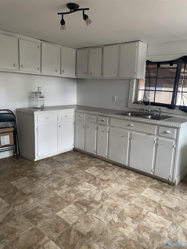 kitchen with gray cabinetry and sink