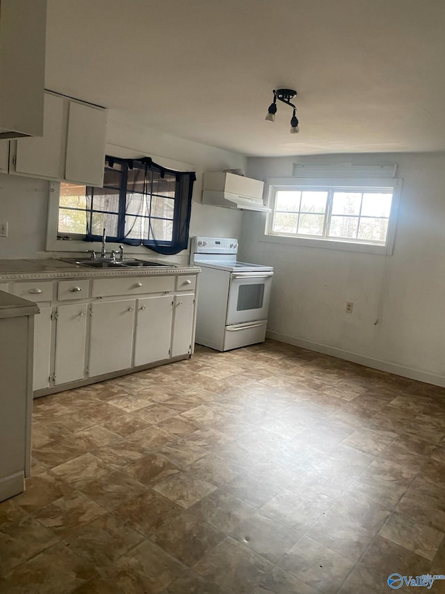 kitchen with white cabinetry, wall chimney range hood, electric range, and sink