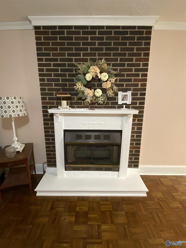 interior details featuring ornamental molding, parquet flooring, and a large fireplace