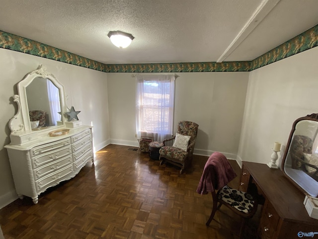 living area featuring a textured ceiling and dark parquet floors