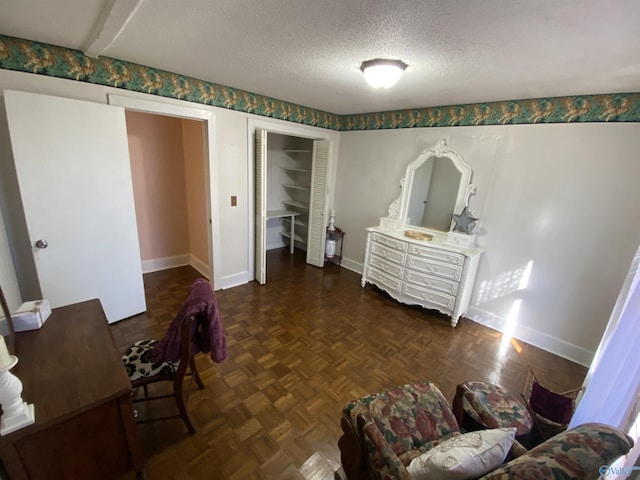 interior space featuring dark parquet floors and a textured ceiling