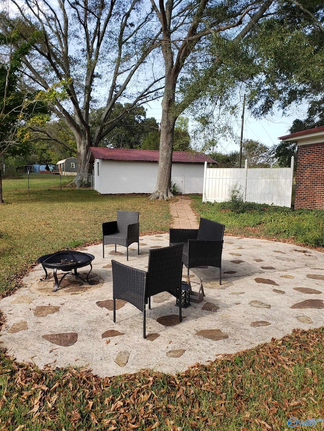 view of patio / terrace featuring an outdoor fire pit