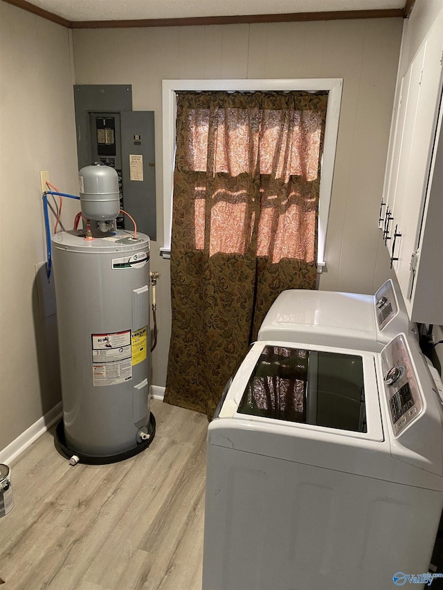 laundry area with hardwood / wood-style flooring, independent washer and dryer, ornamental molding, cabinets, and electric water heater