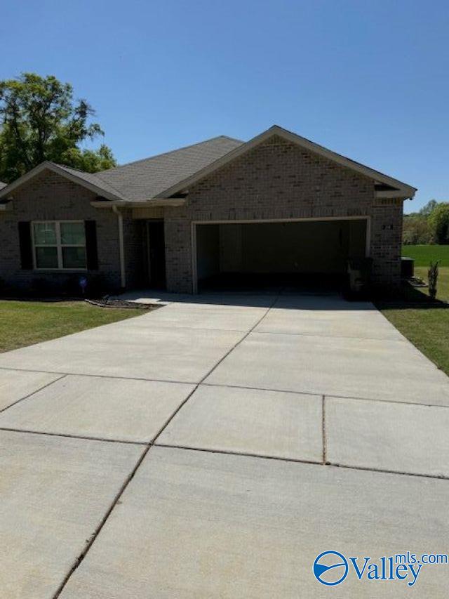 196 Murphy Ln, Madison, AL 35756 - ranch-style house featuring a garage, concrete driveway, a front yard, and brick siding