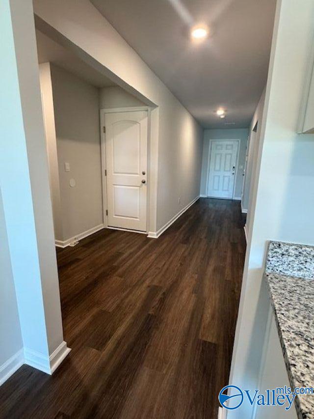 196 Murphy Ln, Madison, AL 35756 - hallway featuring dark wood-type flooring and baseboards