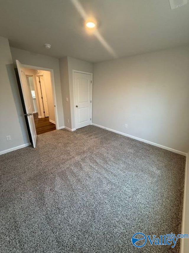 196 Murphy Ln, Madison, AL 35756 - unfurnished bedroom featuring baseboards and dark colored carpet