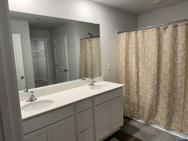 196 Murphy Ln, Madison, AL 35756 - bathroom featuring double vanity, wood finished floors, and a shower with curtain