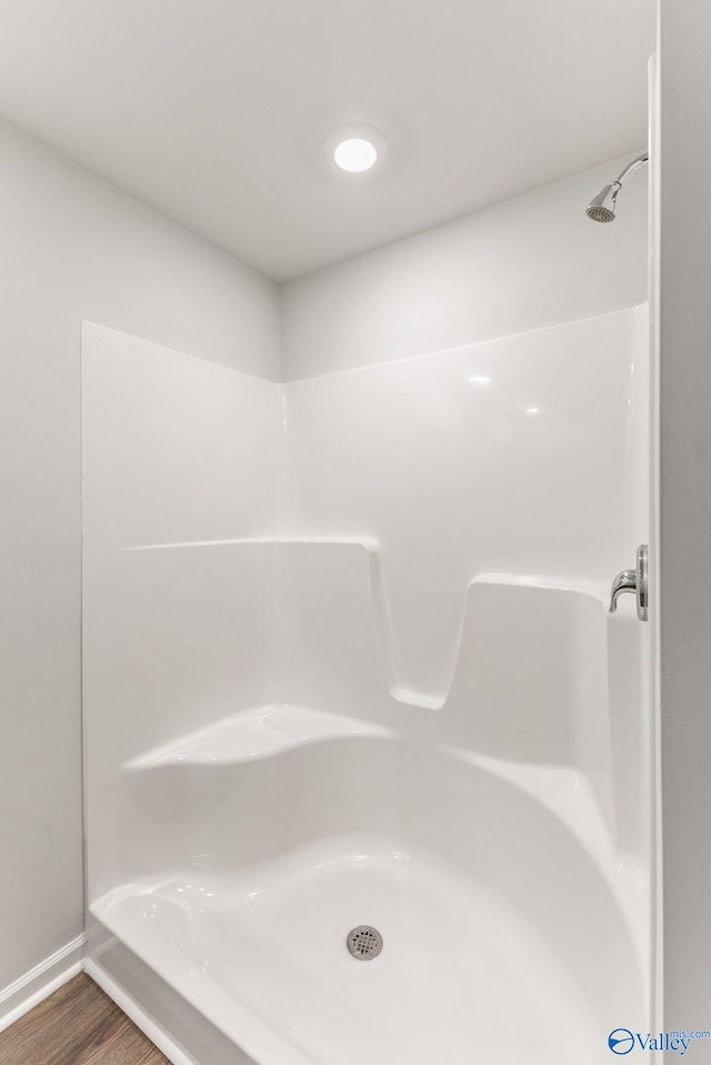 196 Murphy Ln, Madison, AL 35756 - bathroom featuring a shower, wood finished floors, and baseboards