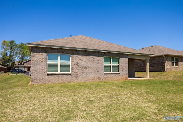 196 Murphy Ln, Madison, AL 35756 - rear view of house featuring a yard, brick siding, and a shingled roof