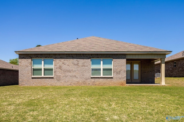 196 Murphy Ln, Madison, AL 35756 - rear view of house featuring a yard, brick siding, and a shingled roof