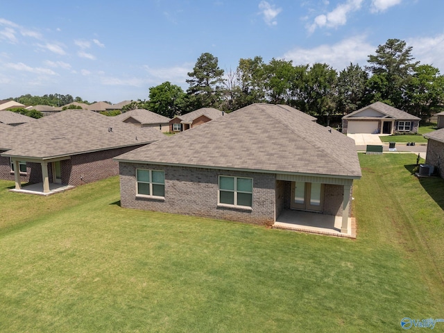 196 Murphy Ln, Madison, AL 35756 - rear view of house featuring a lawn, a patio area, brick siding, and roof with shingles