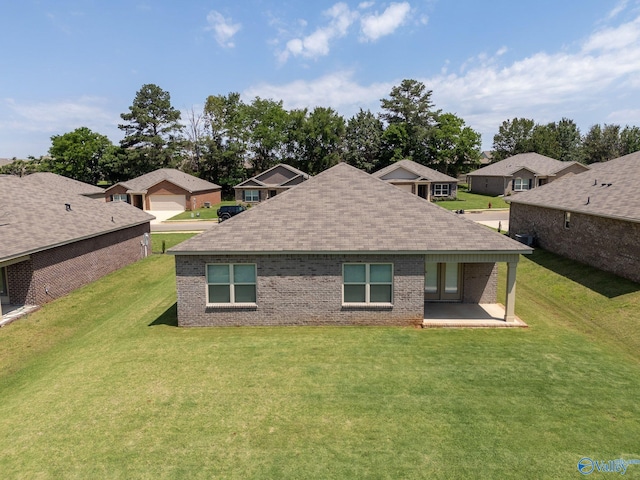 196 Murphy Ln, Madison, AL 35756 - rear view of house featuring a lawn, a shingled roof, brick siding, and a patio area