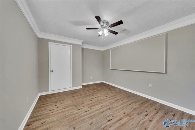 spare room featuring crown molding, baseboards, a textured ceiling, ceiling fan, and wood finished floors