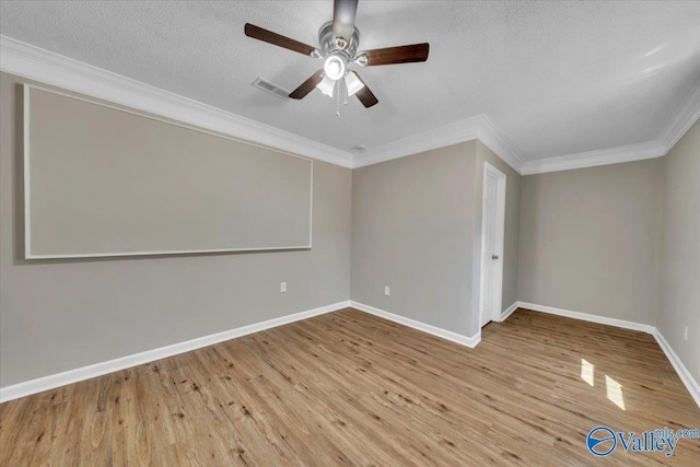 empty room with a textured ceiling, visible vents, ceiling fan, ornamental molding, and wood finished floors