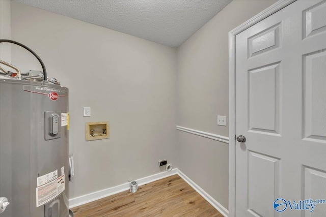 washroom with hookup for an electric dryer, laundry area, electric water heater, light wood-style floors, and hookup for a washing machine